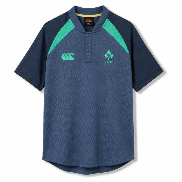 The Ireland 26 Poly Polo by Canterbury features a navy blue design with green accents, a buttoned collar, and embroidered chest logos—this timeless piece from Canterbury is inspired by classic Ireland rugby polos for an authentic athletic style.