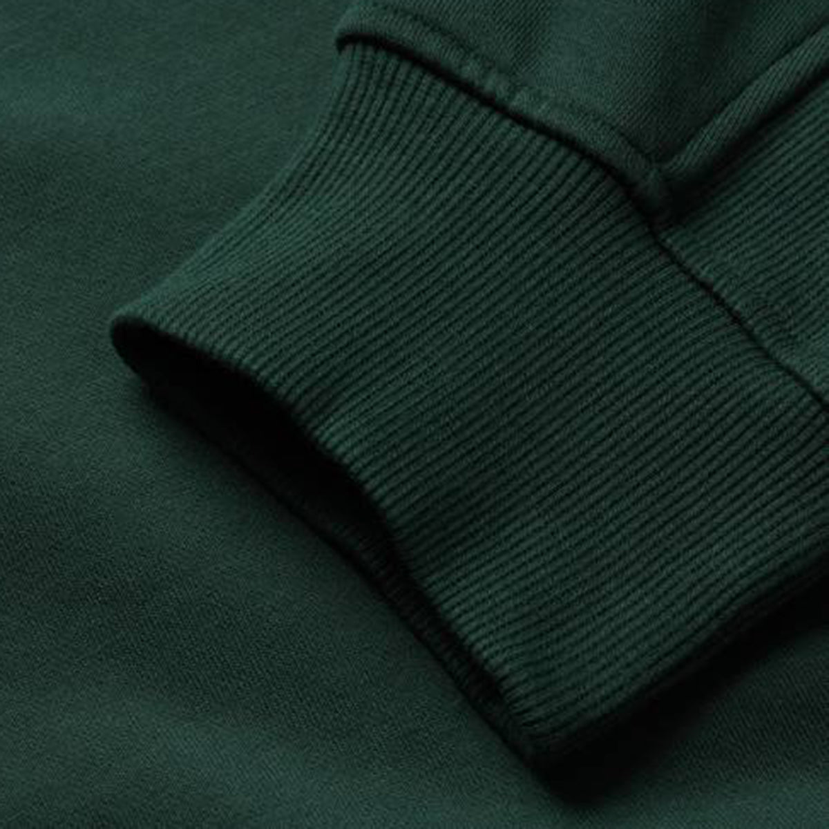 Close-up of a dark green sweatshirt sleeve and cuff featuring ribbed knit texture and stitching details, highlighting the craftsmanship of the Canterbury Ireland 26 Leisure Hoodie.