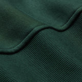 Close-up of dark green ribbed fabric from the Ireland 26 Leisure Hoodie by Canterbury, highlighting its texture and gentle folds.