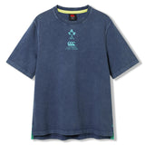 The Ireland 26 Premium OS Washed T-shirt by Canterbury is a blue short-sleeve rugby tee featuring an oversized fit, a stylish faded washed texture, and IRFU and Canterbury logos on the chest.