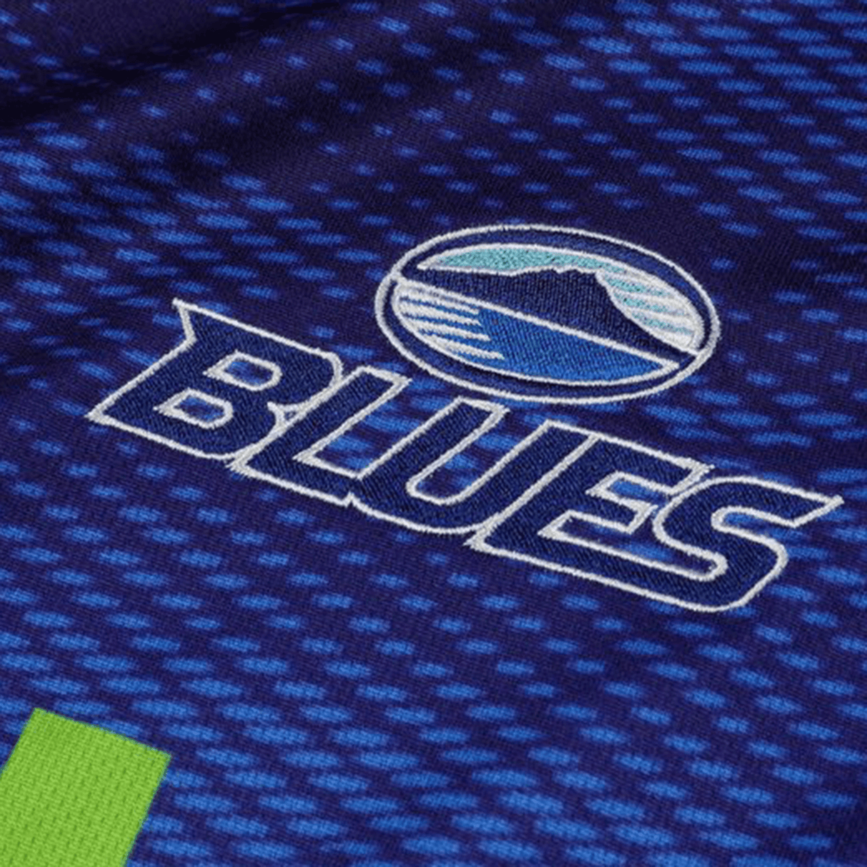 Close-up of the Blues Super Rugby Home Jersey 24 by Classic Sportswear, in moisture-wicking fabric, with a circular logo displaying a wave and sky above "BLUES" in bold white letters.