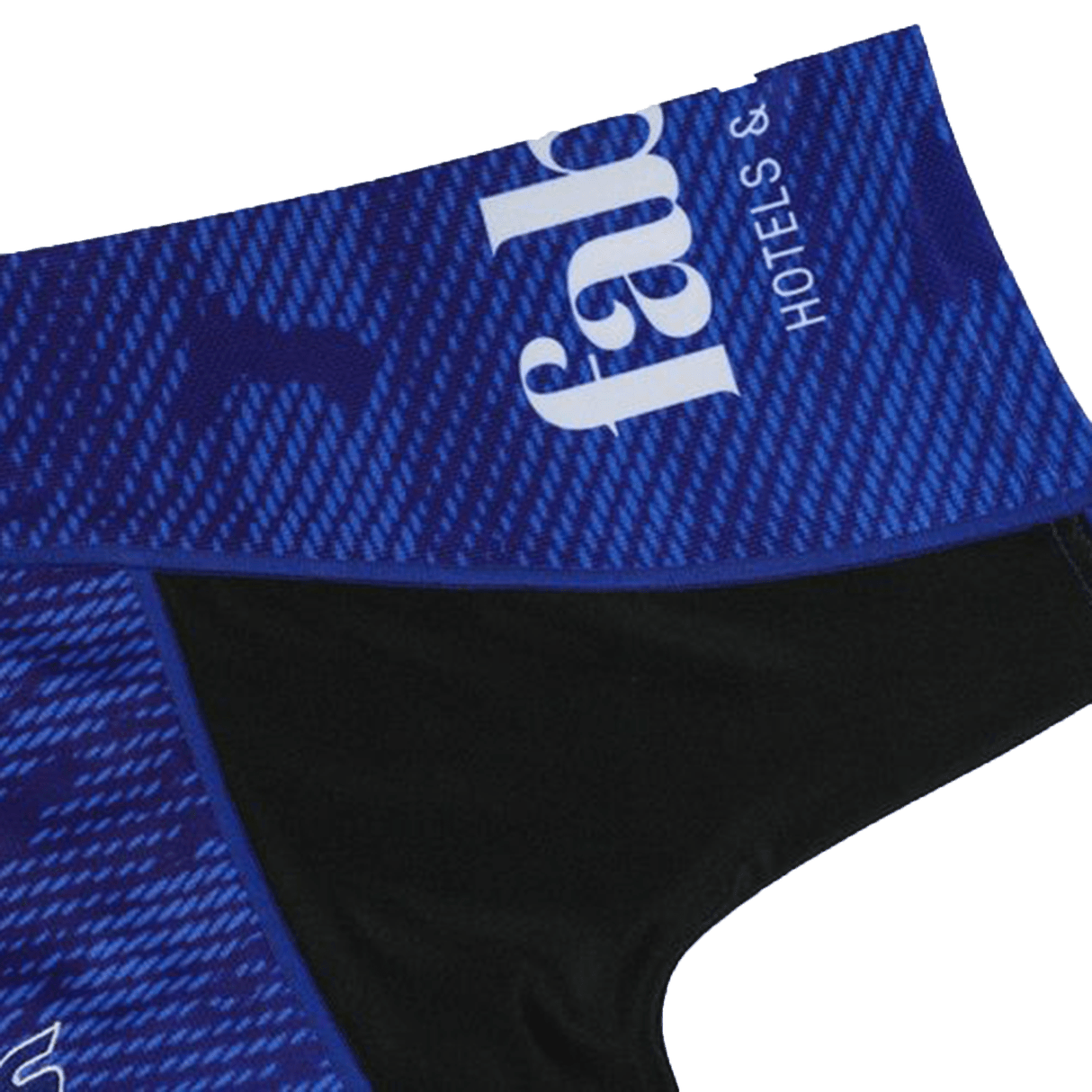 Close-up of the Blues Super Rugby Home Jersey 24 by Classic Sportswear, featuring blue and black abstract patterns with "fab" printed on it. The moisture-wicking fabric ensures comfort and performance, reminiscent of a traditional Blues jersey design.