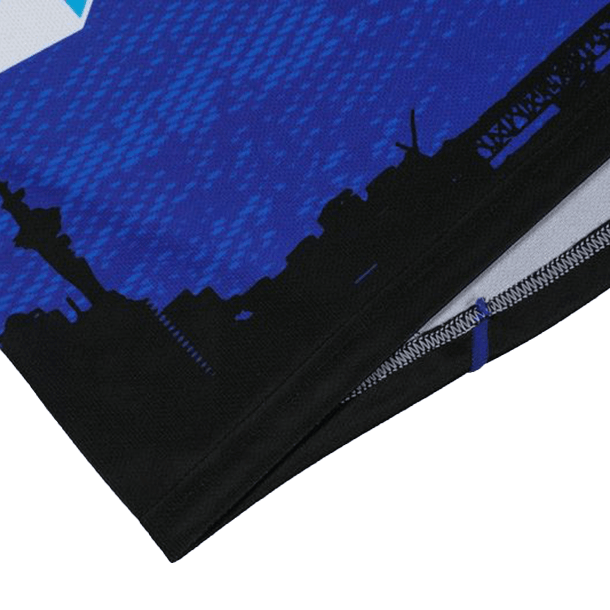 A close-up of the Blues Super Rugby Home Jersey 24 by Classic Sportswear shows a blue and black design with a white edge, city skyline silhouette, and towers. Made from moisture-wicking fabric, it's ideal for Super Rugby fans seeking comfort and style.