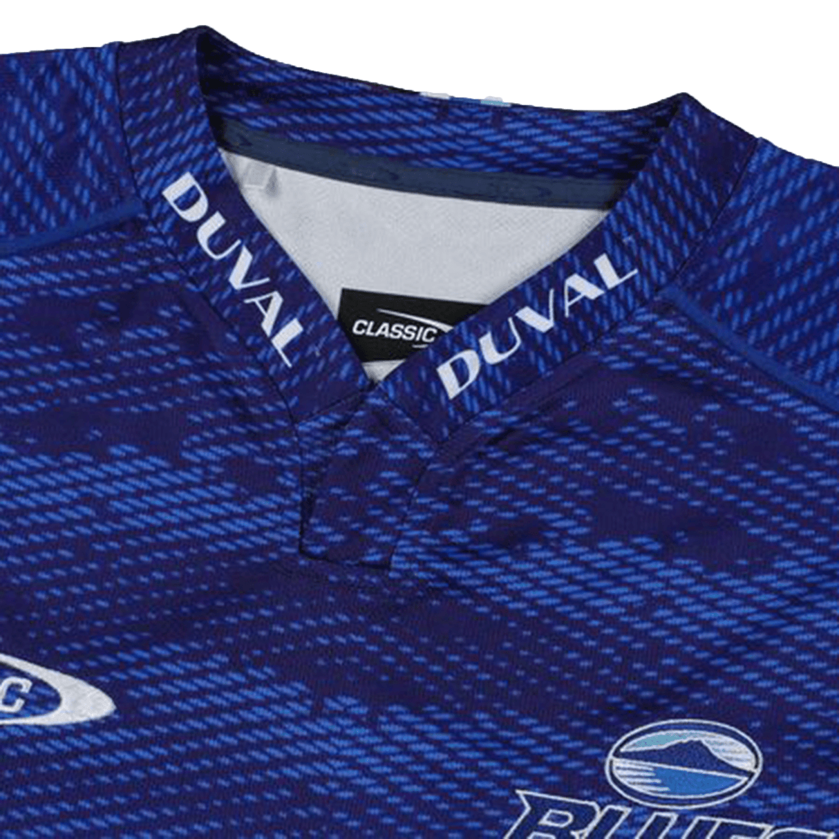 Close-up of the Blues Super Rugby Home Jersey 24 by Classic Sportswear, a blue sports jersey made from moisture-wicking fabric, featuring a dynamic pattern design and "DUVAL" elegantly inscribed on the collar.