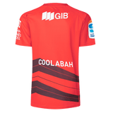 The Crusaders Super Rugby Replica Home Jersey 25/26 by Classic Sportswear is a red sports jersey with "COOLABAH" on the back, black diagonal stripes, and GIB plus other logos on sleeves and upper back. It's perfect for showcasing your Super Rugby pride.
