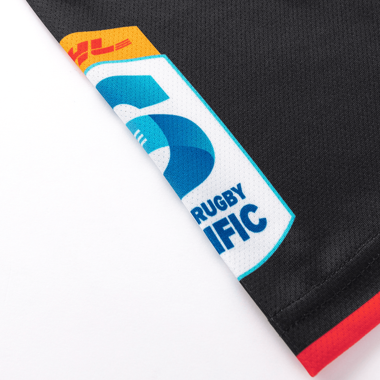 Close-up of a black moisture-wicking fabric with an embroidered "Rugby" and "Pacific" logo, part of the Crusaders Super Rugby Team Polo 25/26 by Classic Sportswear.