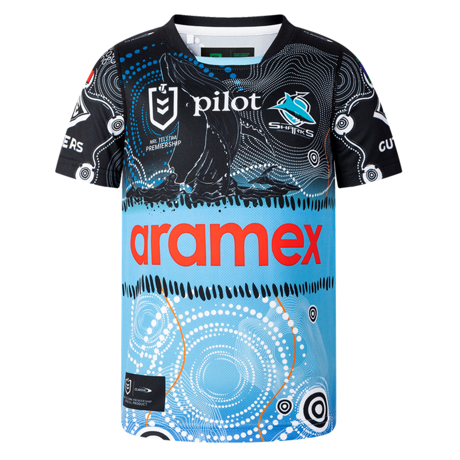 The Sharks Indigenous NRL 25/26 Replica Jersey by Classic Sportswear features Indigenous-inspired black, blue, and white patterns, with "Aramex" and "Pilot" sponsor logos on the front and the Sharks team logo on the chest.
