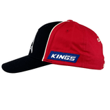 The Dolphins NRL 25/26 Media Cap by Classic Sportswear, featuring a red and black design with a "Kings" logo on the side, is perfect for sports enthusiasts.