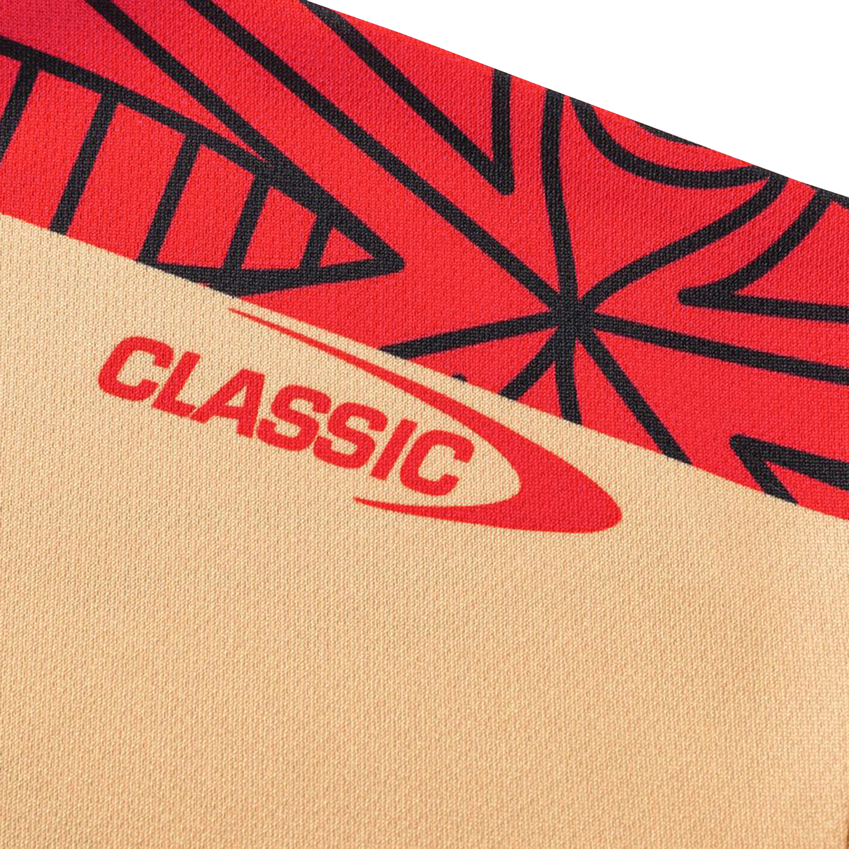 A close-up of fabric from the Dolphins Indigenous NRL 25/26 Replica Jersey by Classic Sportswear, showing beige and red color blocks, black abstract patterns, and "CLASSIC" printed in red.