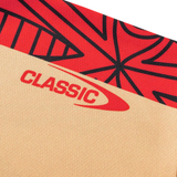 A close-up of fabric from the Dolphins Indigenous NRL 25/26 Replica Jersey by Classic Sportswear, showing beige and red color blocks, black abstract patterns, and "CLASSIC" printed in red.