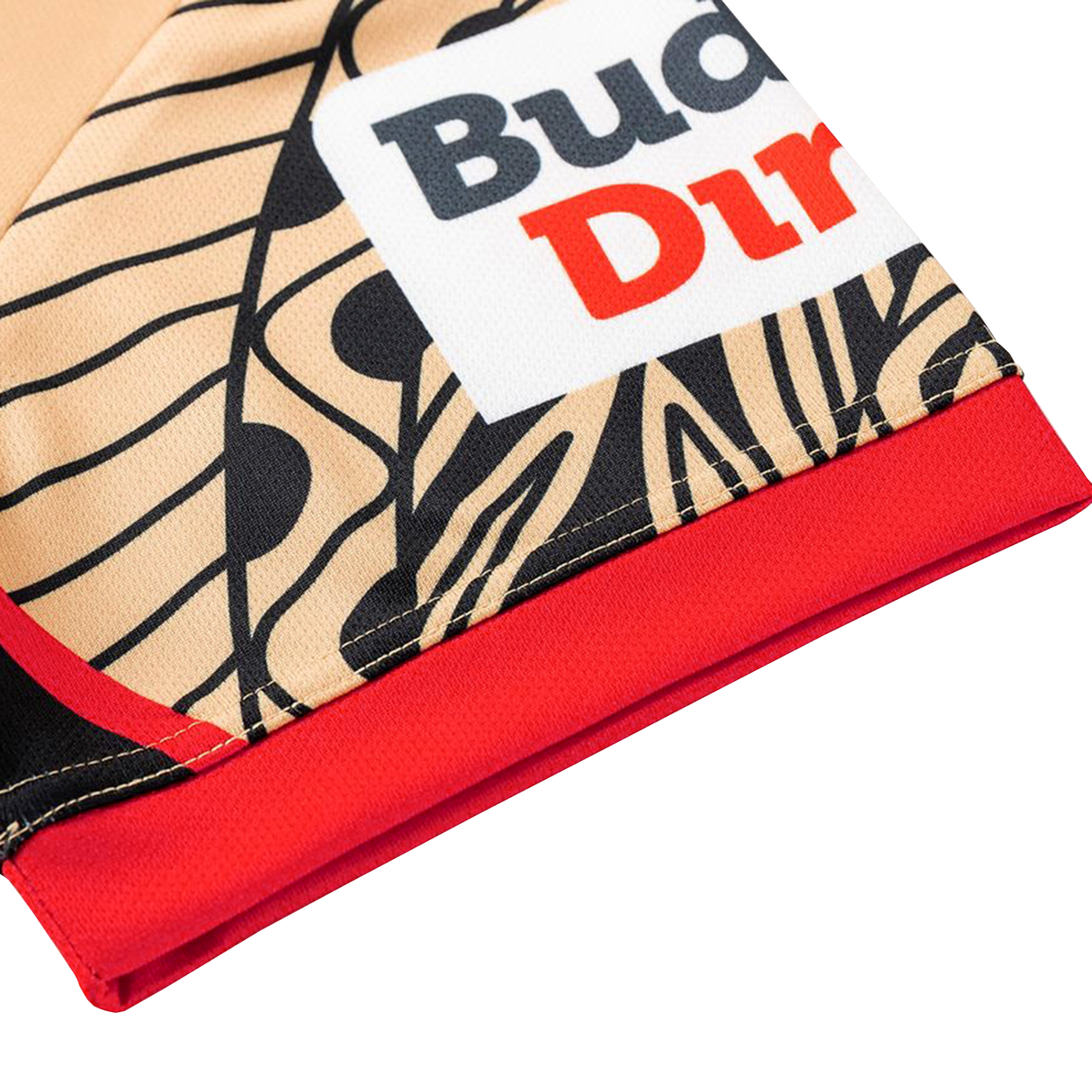Close-up of the Dolphins Indigenous NRL 25/26 Replica Jersey by Classic Sportswear, featuring beige and black patterns, bold lines, red and black text on a white Classic Sportswear label, and a red hem.