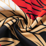 Close-up of the Dolphins Indigenous NRL 25/26 Replica Jersey by Classic Sportswear, featuring a vibrant swirling pattern in red, beige, black, and white with bold graphic lines.