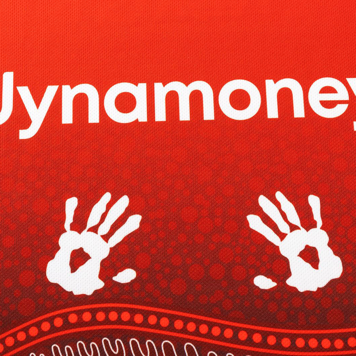 White handprints and the partial word "ynamoney" appear on a red textured surface with dot and wave patterns, inspired by the Dragons Indigenous NRL 25/26 Replica Jersey from Classic Sportswear.