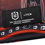 A close-up of a black fabric patch reading "NRL Telstra Premiership Official Product," with white logos and paw prints, featured on the Dragons Indigenous NRL 25/26 Replica Jersey by Classic Sportswear.
