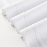 Close-up of four neatly folded edges of white textured fabric, echoing the craftsmanship found in the Dragons NRL 26/27 Replica Home Jersey by Classic Sportswear, arranged in parallel lines on a light surface.