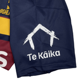 Close-up of a dark blue fabric with a white logo depicting Classic Sportswear's Highlanders Super Rugby Heritage Jersey.