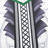 A close-up of white fabric from the NRL Maori All Stars 25/26 Replica Home Jersey by Classic Sportswear shows sublimated geometric black and purple graphics with green accents, evoking a stylized tribal design reminiscent of intricate Maori patterns.