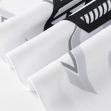 Close-up of the NRL Maori All Stars 25/26 Replica Home Jersey by Classic Sportswear, featuring folded white fabric with bold, abstract black and gray designs and sharp angles reminiscent of sublimated graphics.