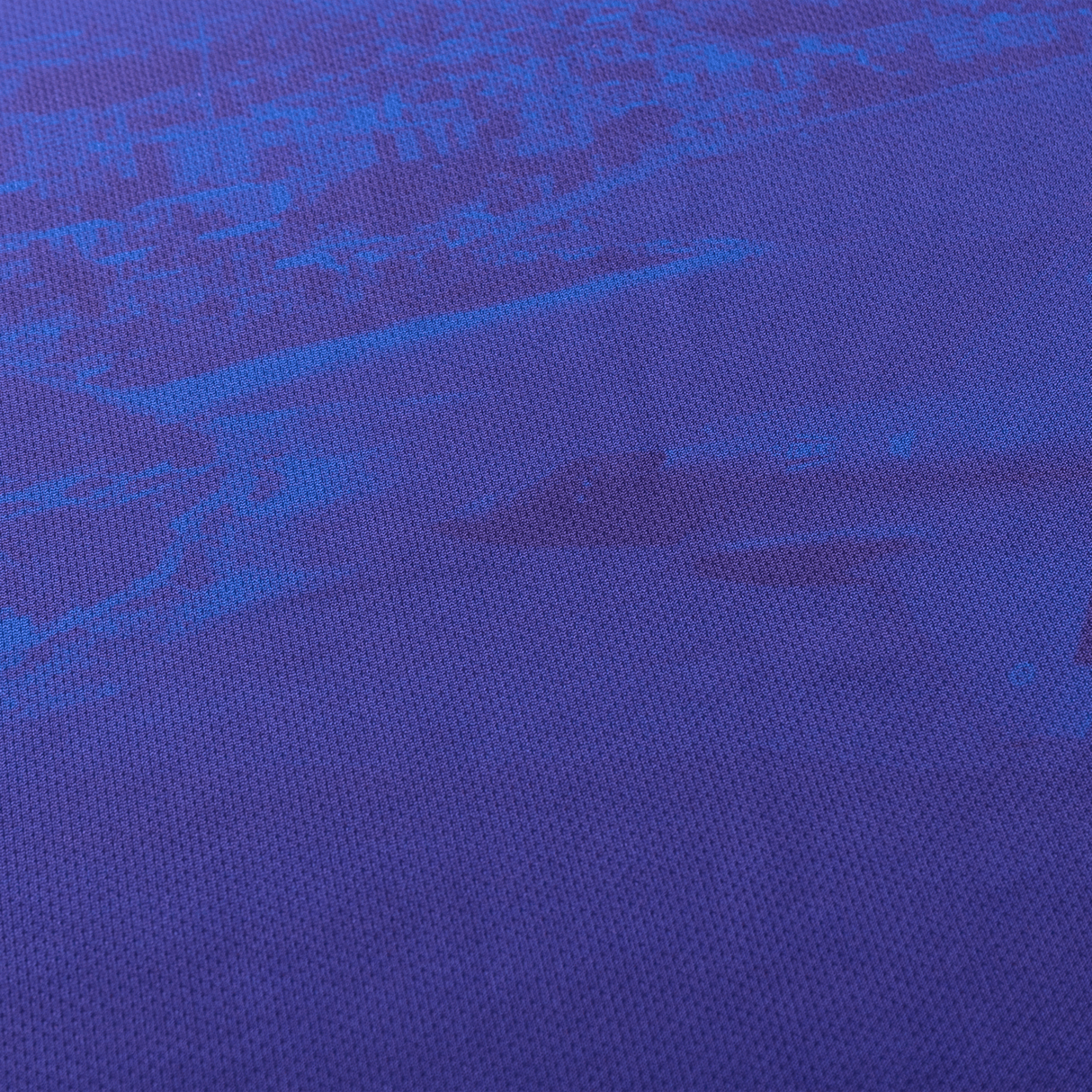 Close-up of a blue textured fabric with a subtle darker blue pattern, reminiscent of the Knights NRL Heritage Jersey by Classic Sportswear.