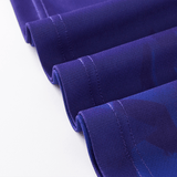 Close-up of blue fabric with neat stitching along the edges, displaying a folded arrangement reminiscent of a Knights NRL Heritage Jersey by Classic Sportswear in classic sportswear style.