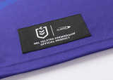 Close-up of a label on a blue fabric with the text "NRL Telstra Premiership Official Product, Classic Sportswear" in white on a black background, embodying the proud tradition of the Knights NRL Heritage Jersey by Classic Sportswear.