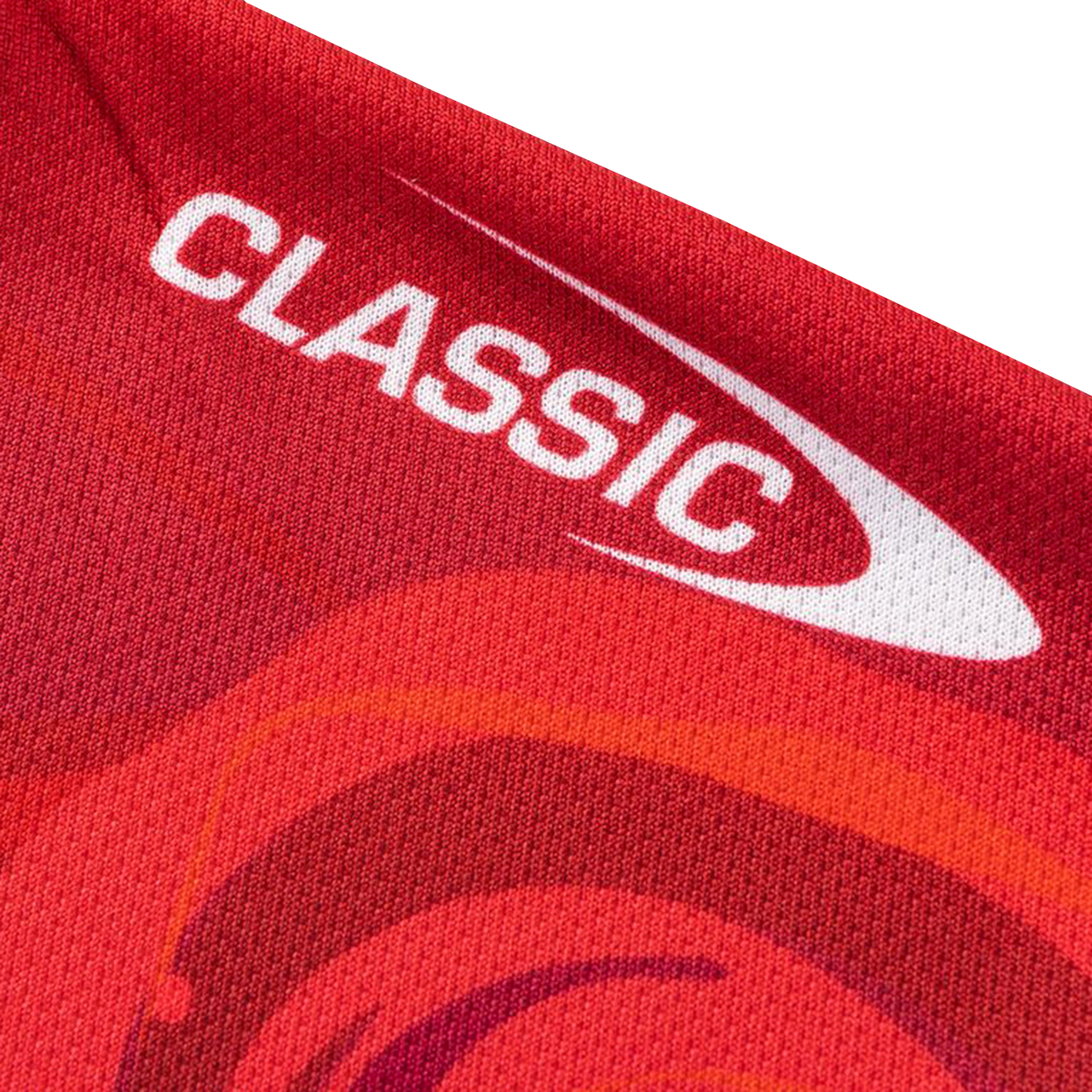 A close-up of red fabric from the Knights Indigenous NRL 25/26 Replica Jersey by Classic Sportswear, featuring "CLASSIC" and a white swoosh.