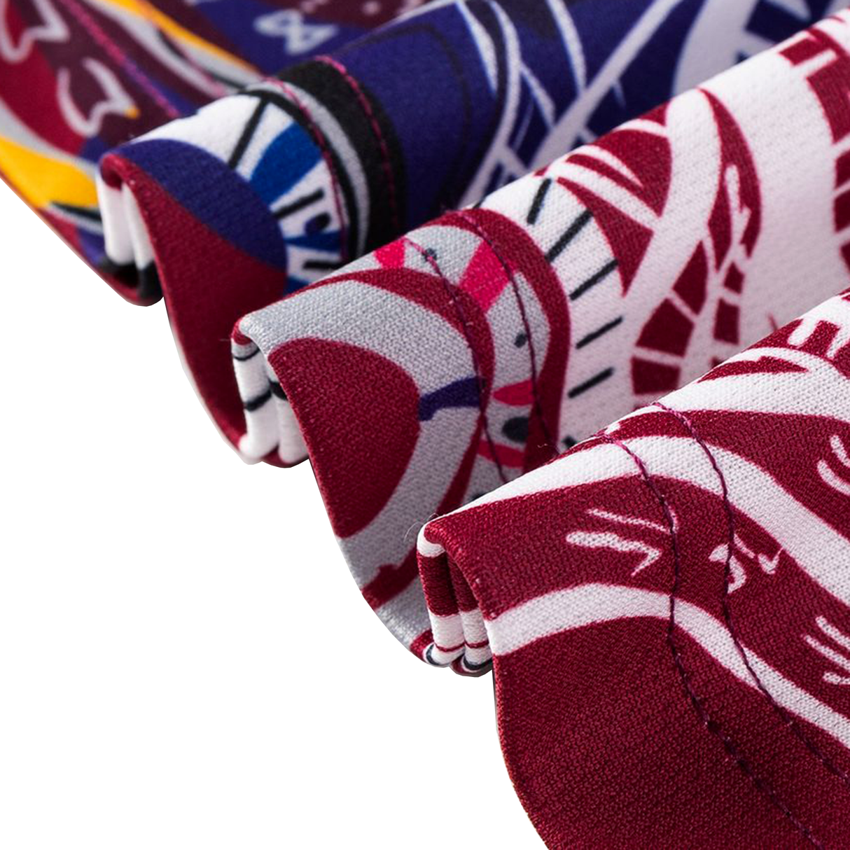 Close-up of fabric with vibrant red, blue, white, and yellow abstract patterns inspired by the Classic Sportswear Knights Indigenous NRL 25/26 Replica Jersey, featuring neatly folded edges.