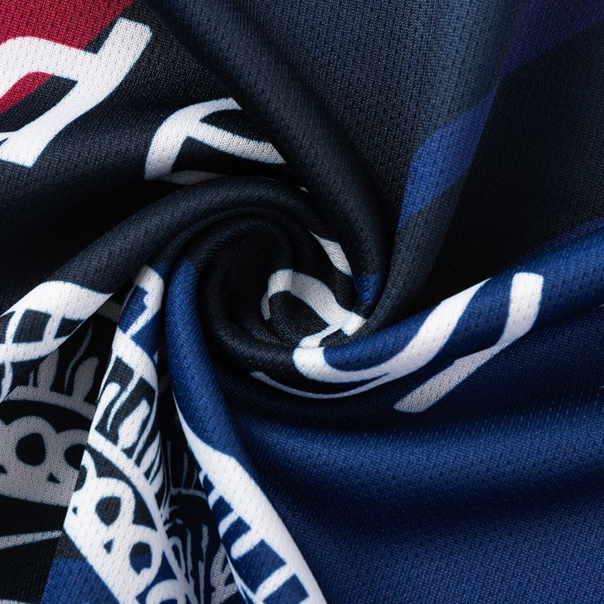 A close-up of the textured, twisted dark blue fabric from the Knights Indigenous NRL 25/26 Replica Jersey by Classic Sportswear, showcasing bold red and white graphic details.