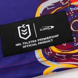 Close-up of a black label on colorful fabric, featuring the NRL Telstra Premiership logo and Classic Sportswear branding from the Knights Indigenous NRL 25/26 Replica Jersey by Classic Sportswear.