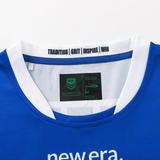 Close-up of the Knights NRL 25/26 Replica Home Jersey by Classic Sportswear, featuring an athletic fit and sublimated graphics. The blue and white jersey has neck labels reading "TRADITION | GRIT | INSPIRE | WIN" and "newera," plus NRL Authentic and Classic Sportswear tags.