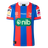The Knights NRL 26/27 Replica Home Jersey by Classic Sportswear features blue and red stripes, the Newcastle Knights logo, sponsor logos, and white accents on the sleeves and collar.