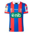 The Knights NRL 26/27 Replica Home Jersey by Classic Sportswear features blue and red stripes, the Newcastle Knights logo, sponsor logos, and white accents on the sleeves and collar.