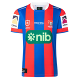 The Knights NRL 26/27 Replica Home Jersey by Classic Sportswear features blue and red stripes, the Newcastle Knights logo, sponsor logos, and white accents on the sleeves and collar.
