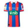 The Knights NRL 26/27 Replica Home Jersey by Classic Sportswear features blue and red stripes, the Newcastle Knights logo, sponsor logos, and white accents on the sleeves and collar.