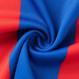 Close-up of red and blue textured fabric spiraled together, capturing the dynamic style of the Knights NRL 26/27 Replica Home Jersey by Classic Sportswear.