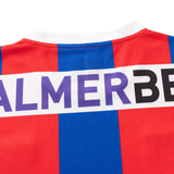 Close-up of the back of a Knights NRL 26/27 Replica Home Jersey by Classic Sportswear, red and blue striped with a white collar and partial "PALMERBE" text visible.
