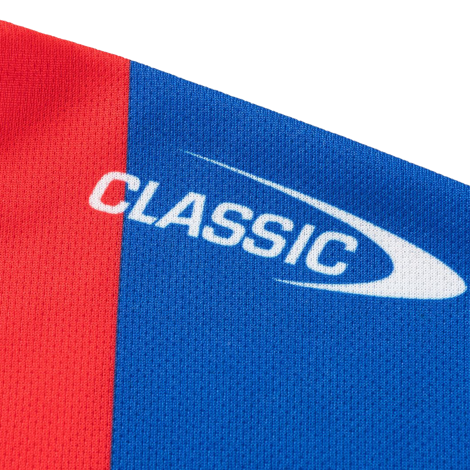 Close-up of red and blue fabric from the Knights NRL 26/27 Replica Home Jersey by Classic Sportswear, showing "CLASSIC" and a white swoosh logo.