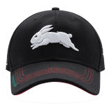 The Rabbitohs NRL 25/26 Media Cap by Classic Sportswear is a black quick-drying polyester baseball cap featuring an embroidered white rabbit on the front and red stitching accents on the brim, showcasing stylish branding.