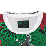 Close-up of the Rabbitohs Indigenous NRL 25/26 Replica Jersey collar by Classic Sportswear, showing "OLDEST • PROUDEST • LOUDEST" printed inside plus size L and NRL Authentics branding—a unique detail of this vibrant jersey.