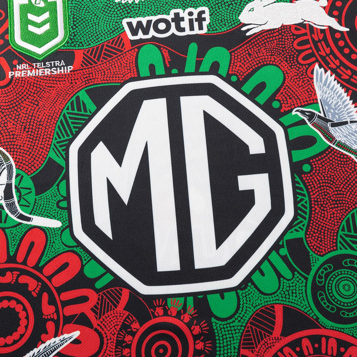 Close-up of the Rabbitohs Indigenous NRL 25/26 Replica Jersey by Classic Sportswear, with a bold MG logo, Aboriginal-inspired designs, animal motifs, and official NRL and sponsor logos.
