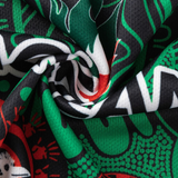Close-up of a twisted fabric with bold, abstract black, green, white, and red patterns inspired by the Rabbitohs Indigenous NRL 25/26 Replica Jersey by Classic Sportswear.