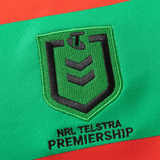 The Rabbitohs NRL 25/26 Replica Home Jersey by Classic Sportswear features an embroidered NRL Telstra Premiership logo on a red and green fabric background, embodying the essence of a Rabbitohs Jersey.