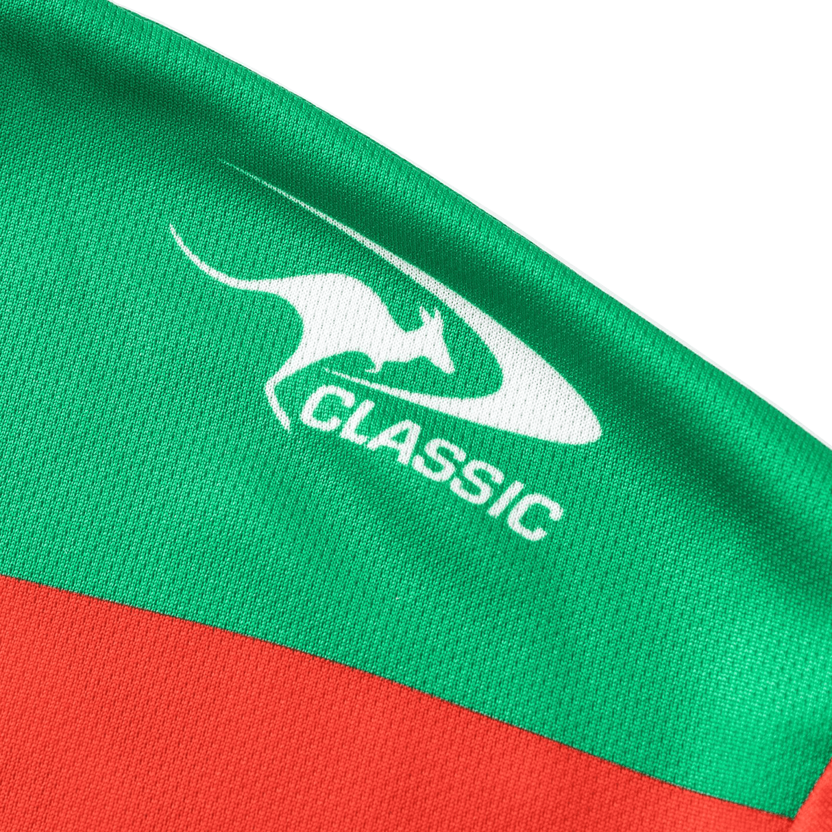 Close-up of a green and red fabric featuring a white kangaroo logo and the words "Rabbitohs NRL 25/26 Replica Home Jersey by Classic Sportswear," reminiscent of the iconic Rabbitohs jersey.