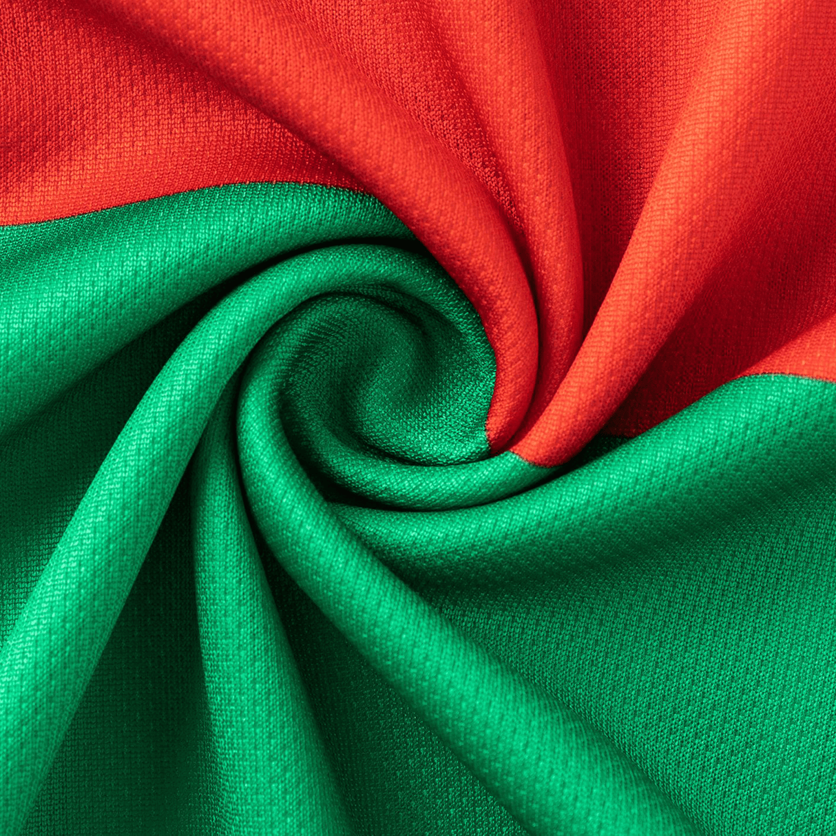 The Rabbitohs NRL 25/26 Replica Home Jersey by Classic Sportswear features vibrant red and green sections in a swirling pattern, evoking a classic sportswear style.