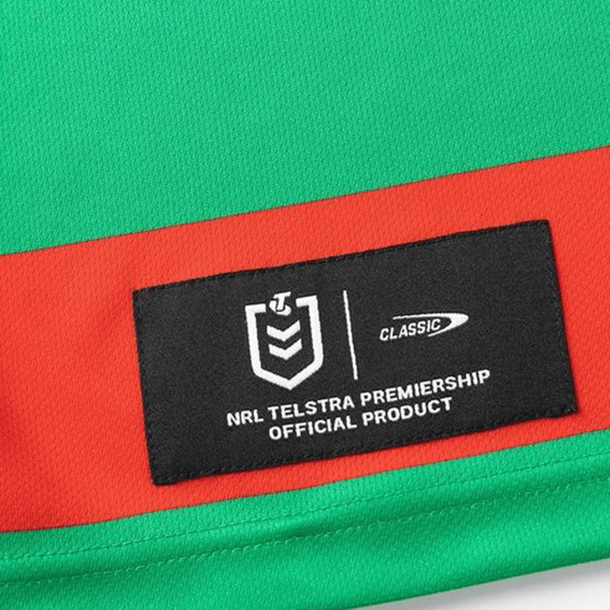 Close-up of a green and red Rabbitohs NRL 25/26 Replica Home Jersey by Classic Sportswear, featuring the official NRL Telstra Premiership label and iconic design.