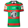 The Rabbitohs NRL 26/27 Replica Home Jersey by Classic Sportswear features red and green stripes, sponsor logos (MG, wotif, Budget Direct), and a black rabbit emblem—an authentic South Sydney home jersey.
