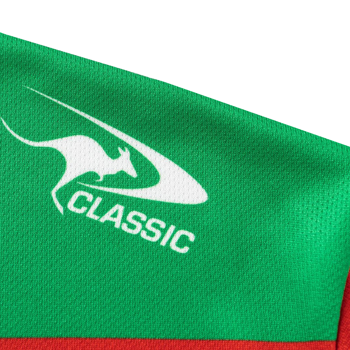 A close-up of green fabric with a white kangaroo logo and "CLASSIC" text, showing the detail of the Rabbitohs NRL 26/27 Replica Home Jersey by Classic Sportswear.