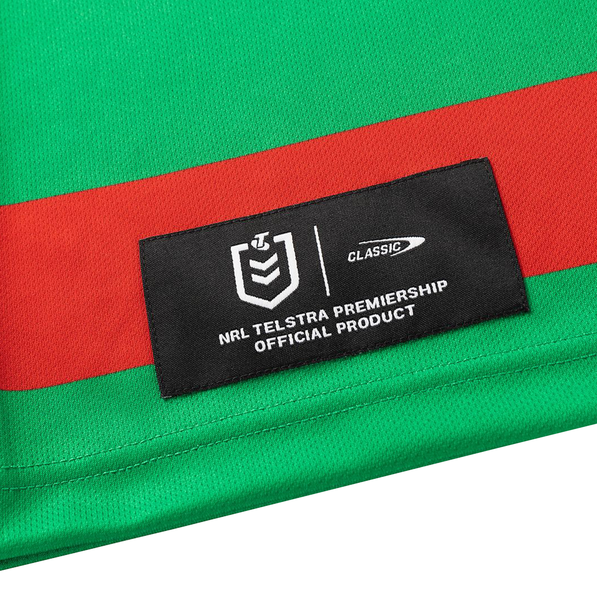 A close-up of the Rabbitohs NRL 26/27 Replica Home Jersey by Classic Sportswear, featuring green and red panels and a black label indicating it’s an official NRL Telstra Premiership product.