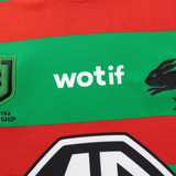 Close-up of the Rabbitohs NRL 26/27 Replica Home Jersey by Classic Sportswear, featuring red and green stripes, "wotif," rabbit logo, shield emblem, and partial "TRO SHIP" text—ideal rugby performance apparel.
