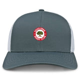 The Chico Oaks Retro Trucker Cap by EMB S&S Activewear features a gray and white design, an embroidered circular red "Chico Oaks Rugby Club" logo with a green oak tree on the front, and an adjustable classic snapback closure.
